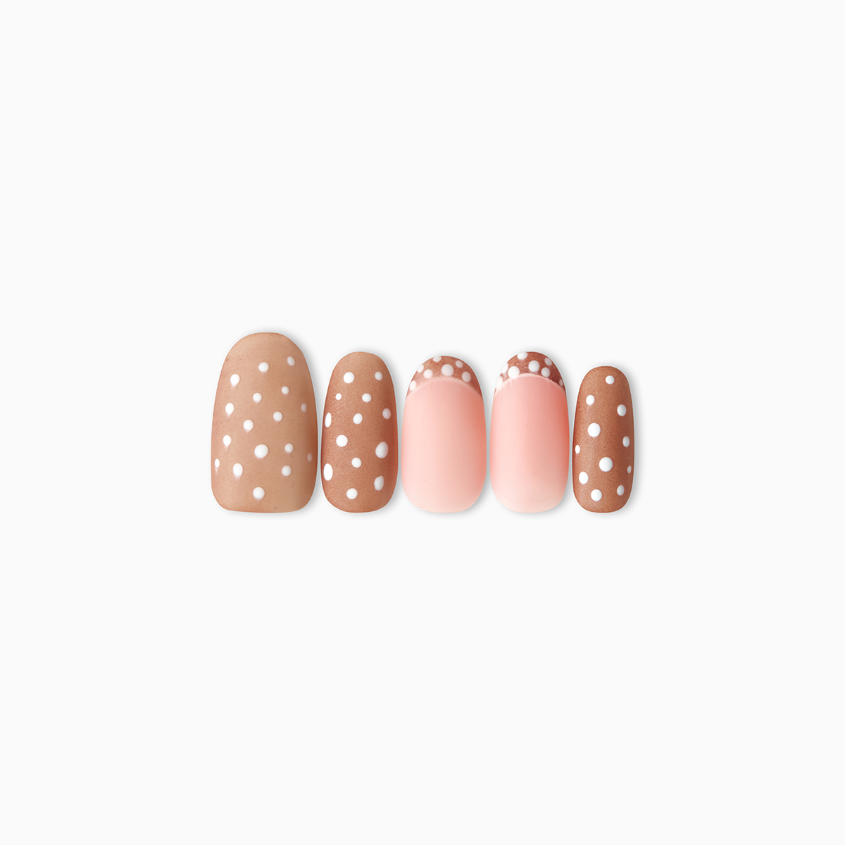 Handmade oval press-on nails featuring a warm latte-brown base with white polka dots, including two accent nails with a pinkish nude base and polka-dotted French tips.