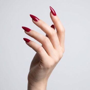 Berry Heat - Deep berry red press-on nails, medium almond shape, glossy finish. | worn on hand 2 | So Does Nails