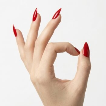 Classic Flame - Vibrant true red press-on nails, medium almond shape, glossy finish. | worn on hand 2 | So Does Nails