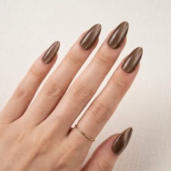 Cocoa Glaze - Dark cocoa brown cat-eye almond press-on nails with glossy reflective finish. | worn on hand 2 | So Does Nails