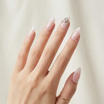 Crystal Petal - Soft pink almond press-on nails with white French tips and silver crystal clusters. | worn on hand 2 | So Does Nails