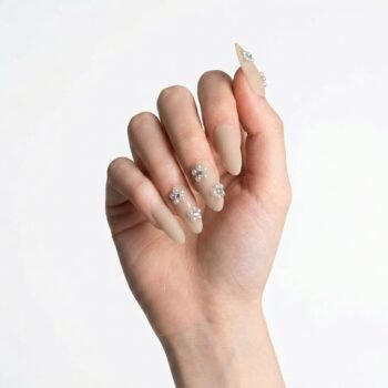 Fleur Beige - Handmade matte beige oval press-on nails decorated with small pearl flowers and rhinestones. | worn on hand 2 | So Does Nails