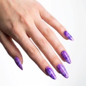 Grape Marble - Almond press-on nails with a vibrant purple marble effect, blending deep violet and lavender swirls. | worn on hand 2 | So Does Nails