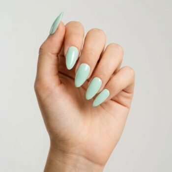 Mint Breeze - Pastel mint green press-on nails, medium almond shape, glossy finish. | worn on hand 2 | So Does Nails