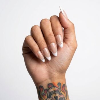 Modern Nude Handmade almond press-on nails with a classic French tip design on a nude base. | worn on hand 2 | So Does Nails