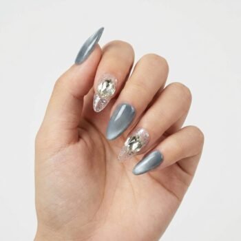 Nebula Ice - Handmade medium almond press-on nails featuring a shimmering silver cat-eye finish on three nails and transparent accent nails with silver glitter and large clear crystal clusters. | worn on hand 2 | So Does Nails