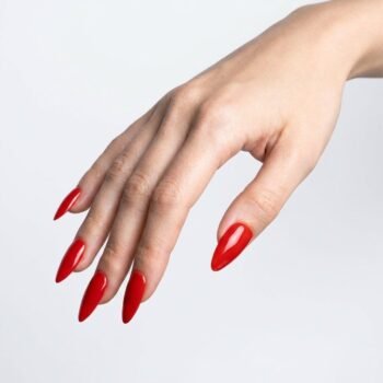Red Alert - Classic bright red press-on nails, medium almond shape, glossy finish. | worn on hand 2 | So Does Nails