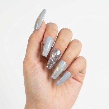 Silver Sonata - Handmade coffin press-on nails in a soft grey shimmer finish, featuring gold leaf flakes, white shell fragments, and a center accent nail with 3D metallic silver liquid ripples. | worn on hand 2 | So Does Nails