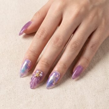 Siren Shell - Purple jelly almond press-on nails with 3D seashell texture, gold starfish charms, and aurora flakes. | worn on hand 2 | So Does Nails