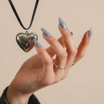 Soft Concrete - Medium cool grey press-on nails, medium almond shape, glossy finish. | worn on hand 2 | So Does Nails